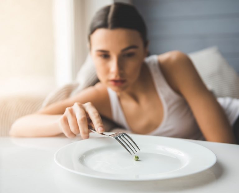 a woman with an eating disorder playing the pea on the plate