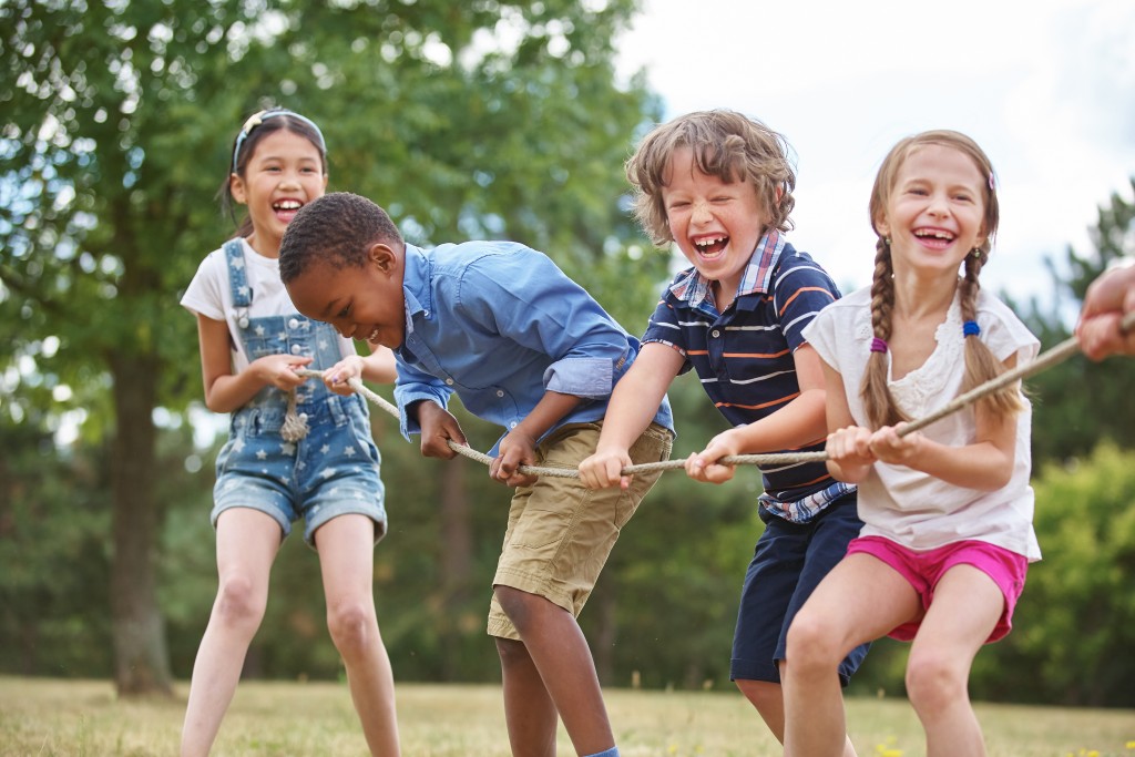 children playing tug o war at the park