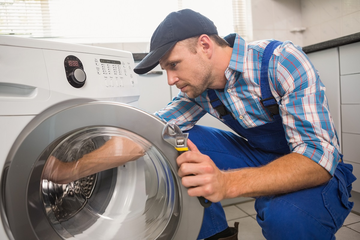 handyman fixing the washing machine