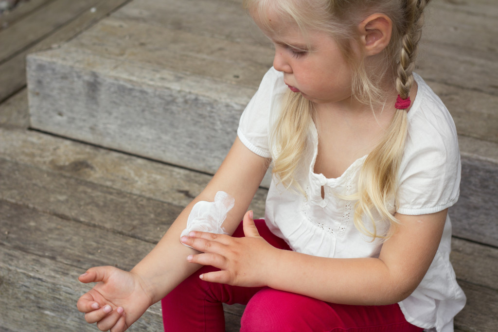 Girl applying sunscreen on skin