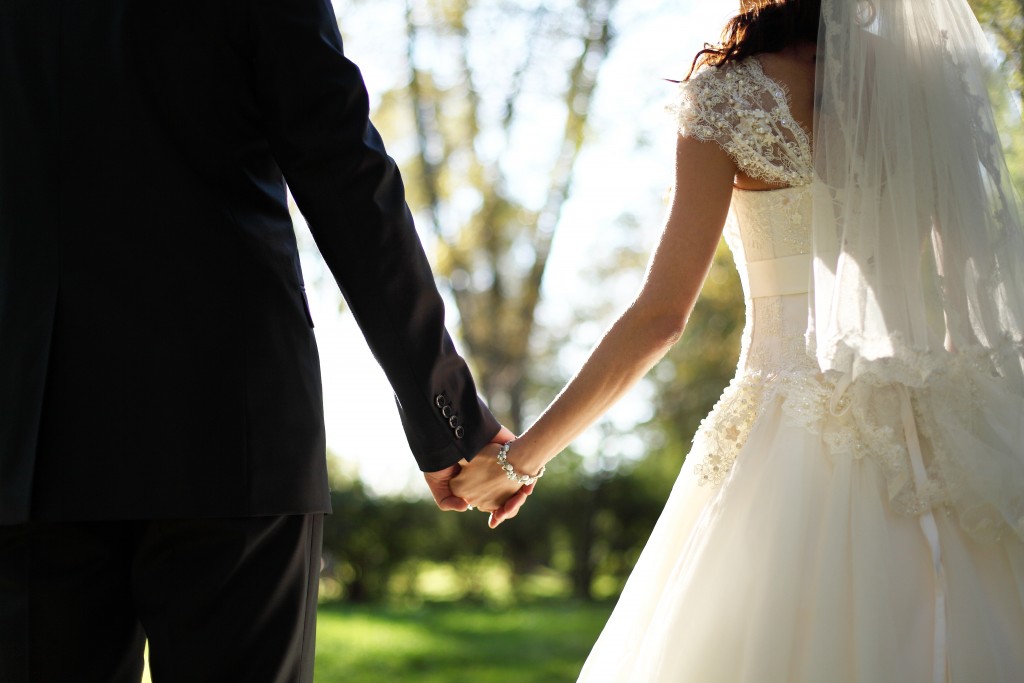 couple getting married holding hands