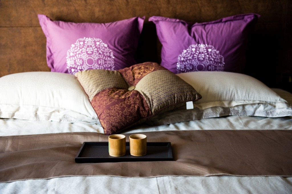 cups on a bed in a hotel room