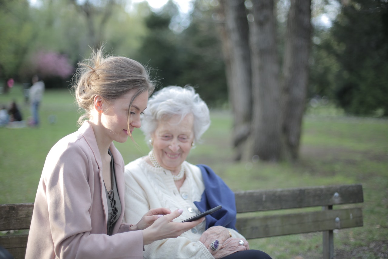 young woman talking to elder woman