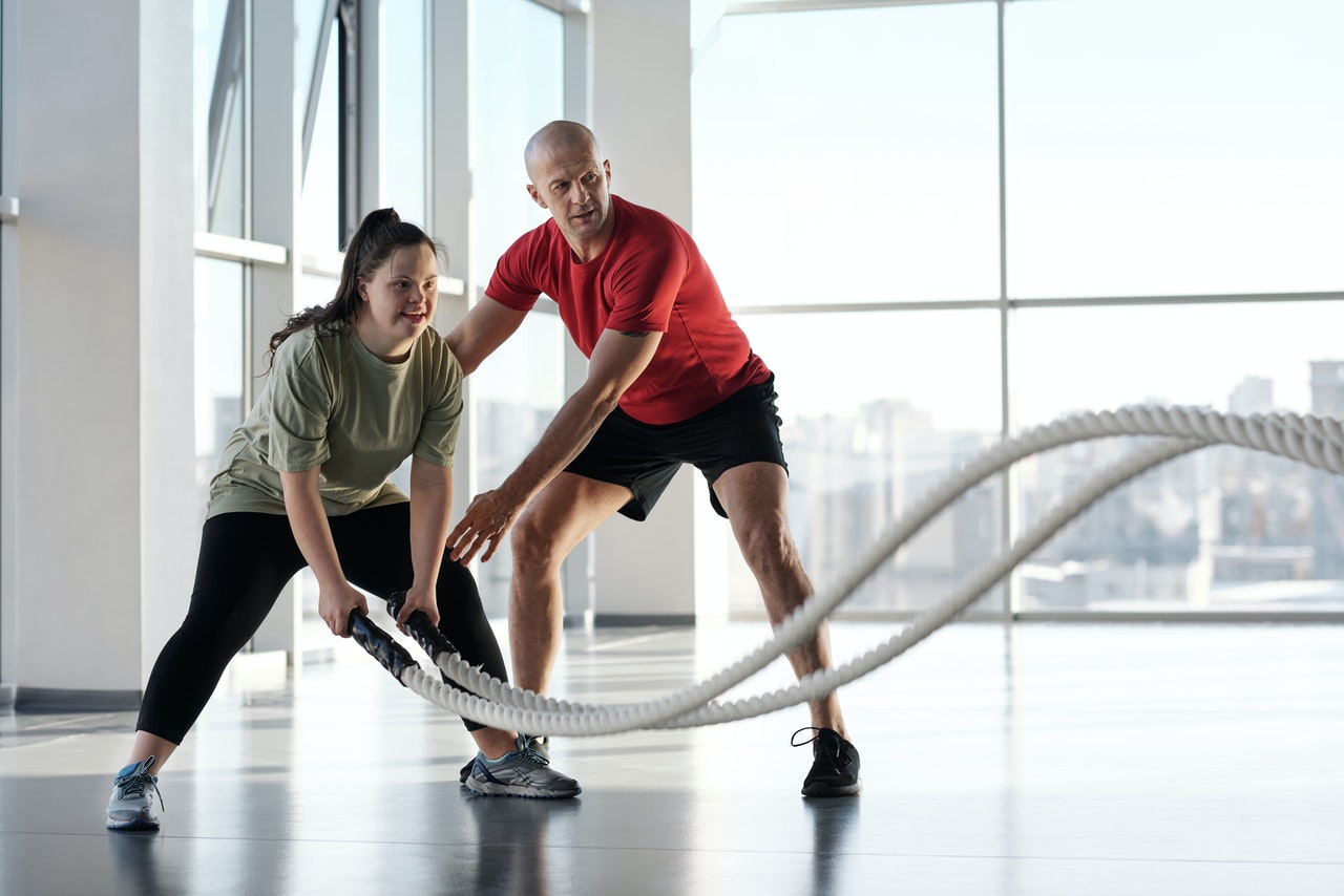 person with a coach doing a work out session