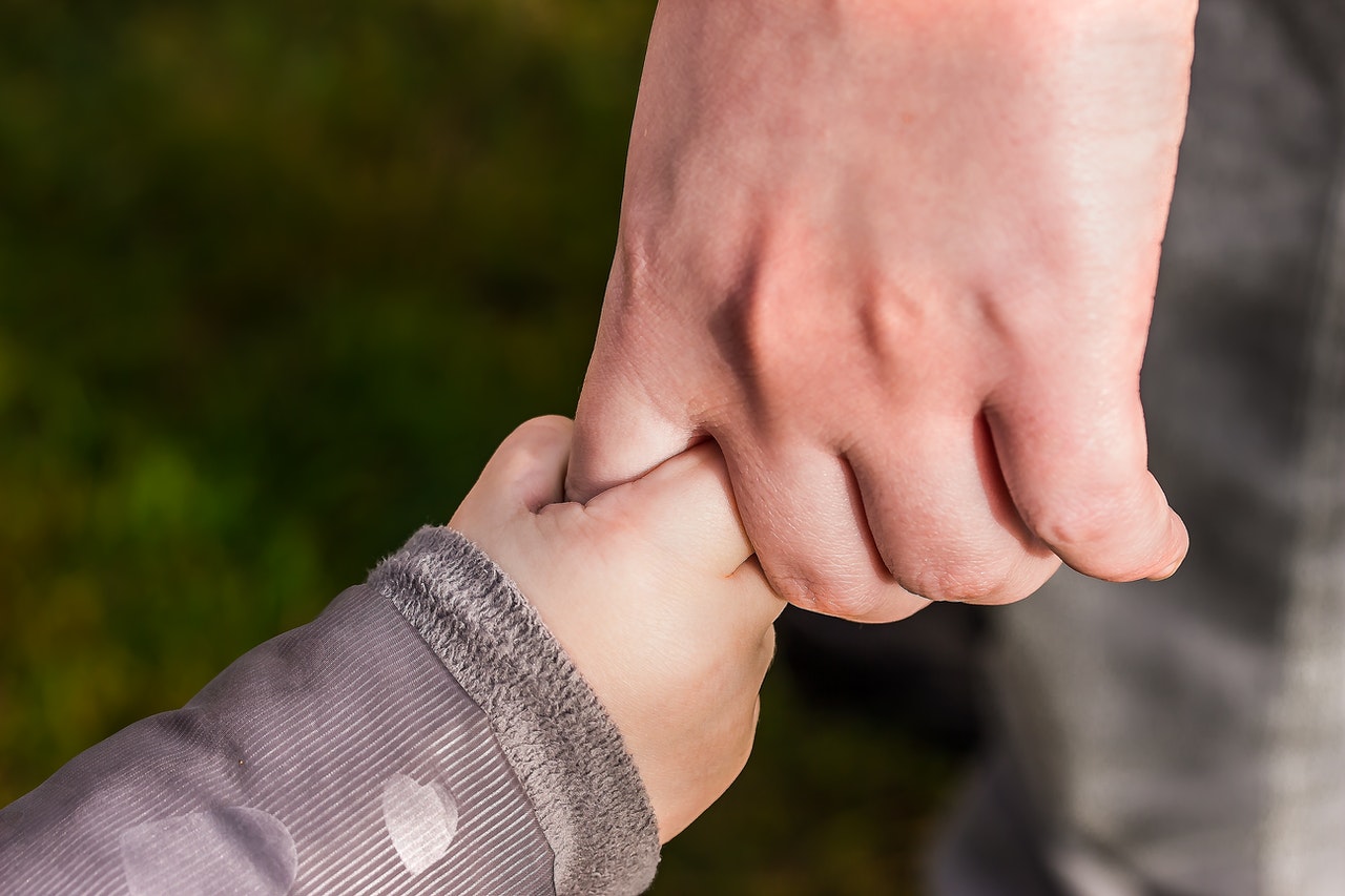 parent and child holding hands