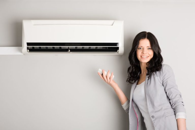 woman using air conditioning unit