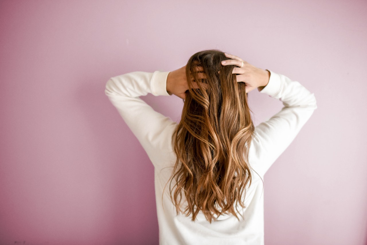 woman touching her long hair