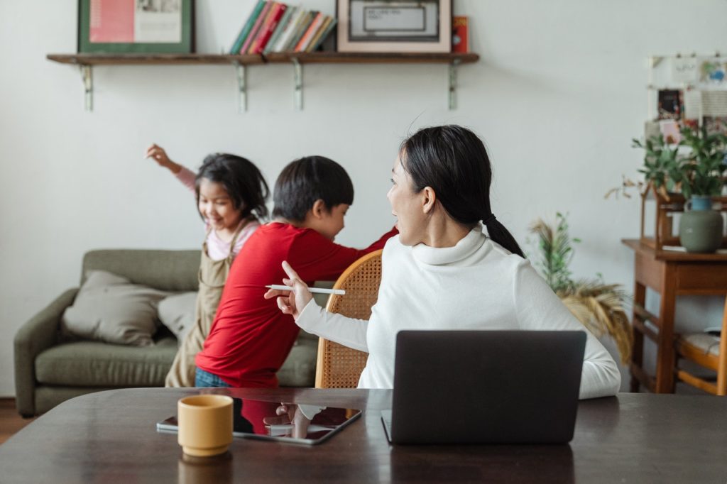 kids playing behind their mother