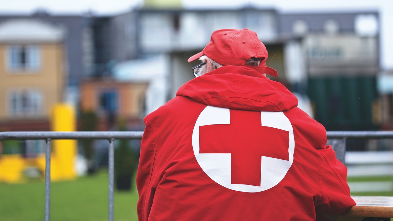 red cross logo behind jacket