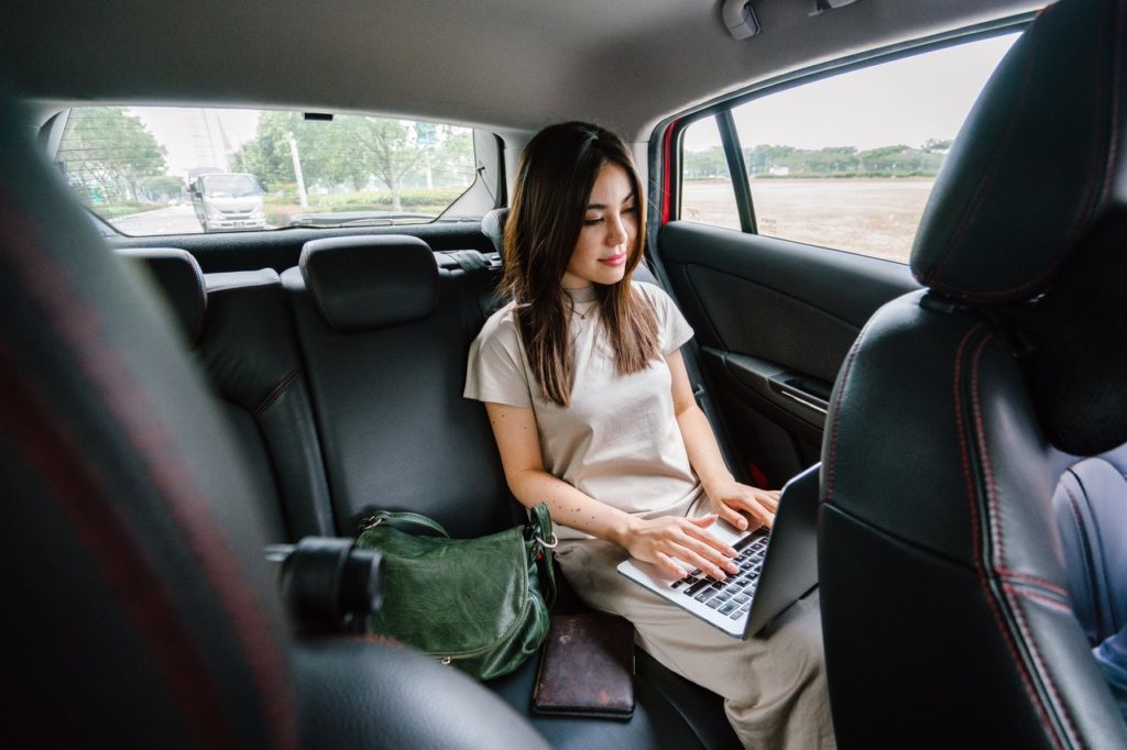 woman using her computer in a car