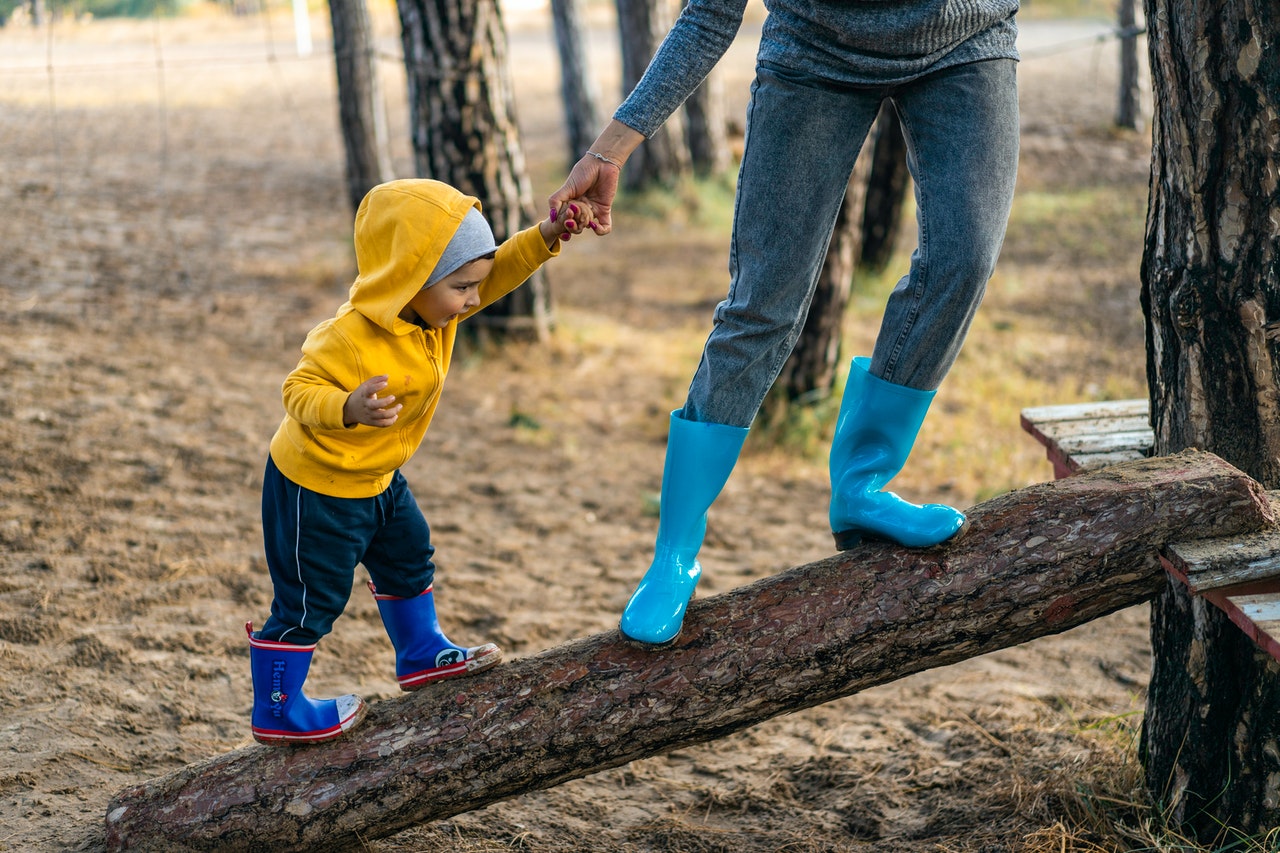 kids walking on a fallen tree