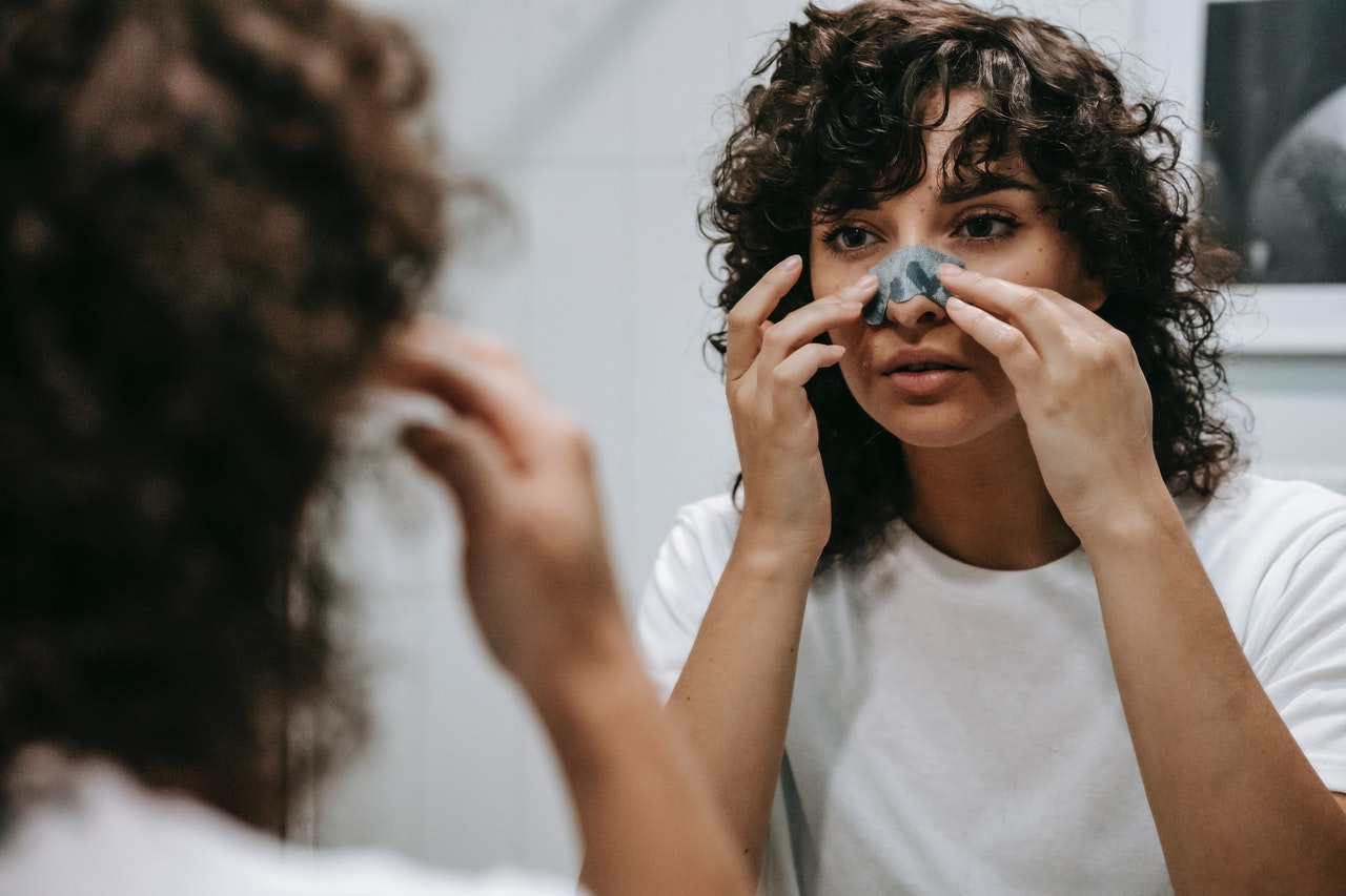 woman with a bandage over her nose