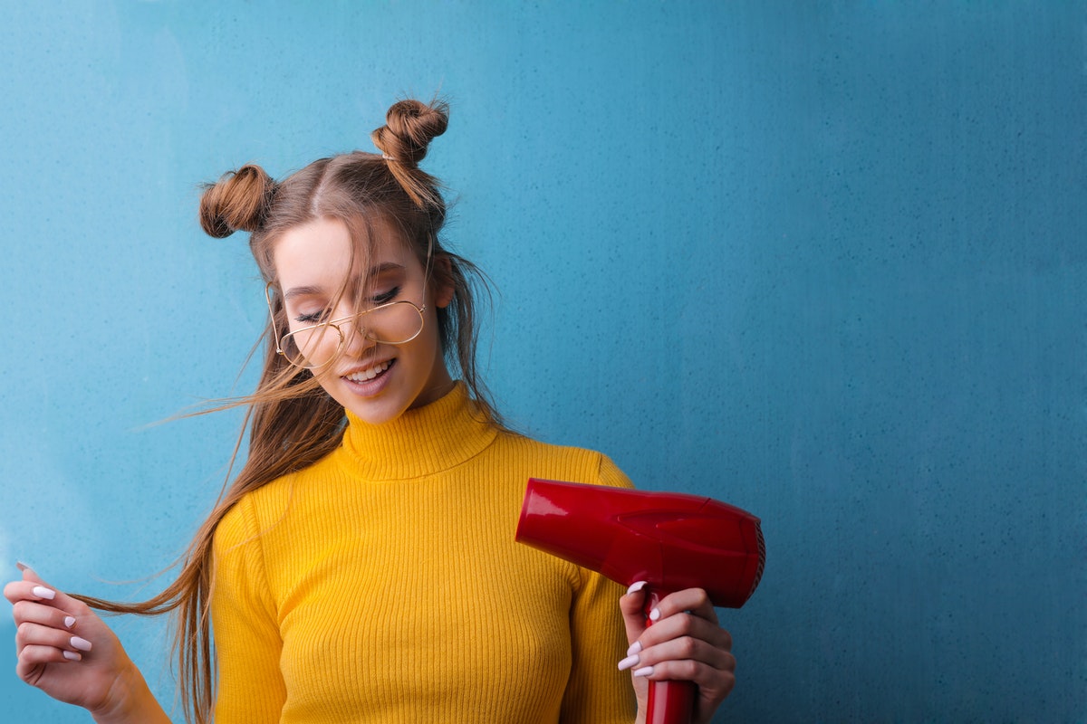 woman using hairdryer