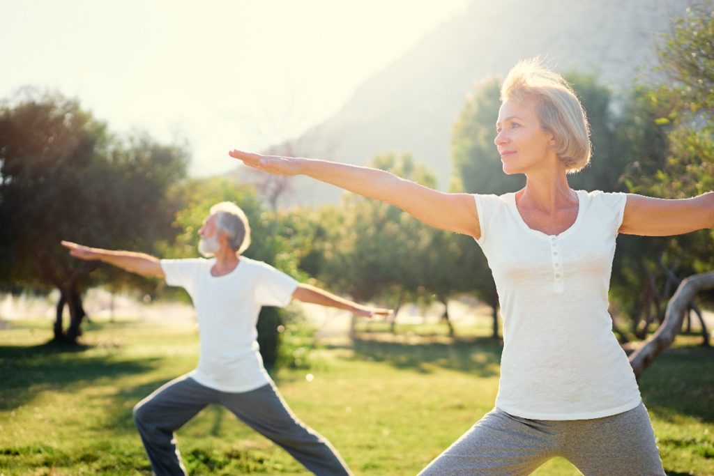 man and woman doing yoga