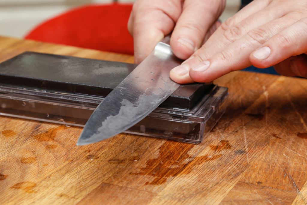 person sharpening a knife