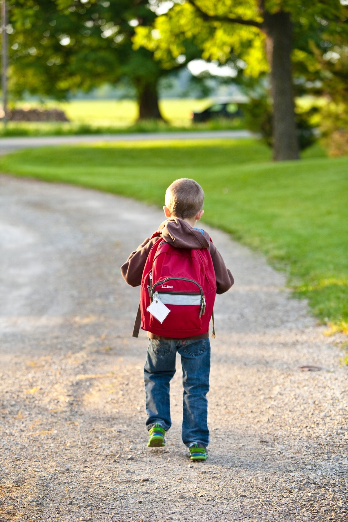 kid carrying a backpack