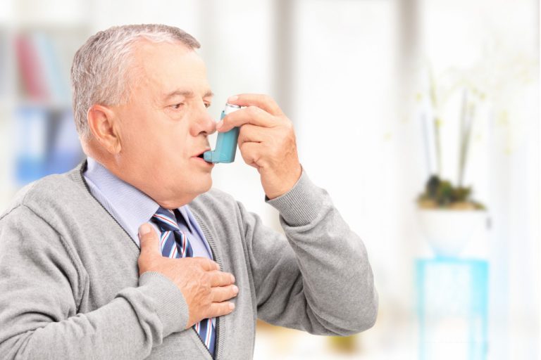 man taking inhaler