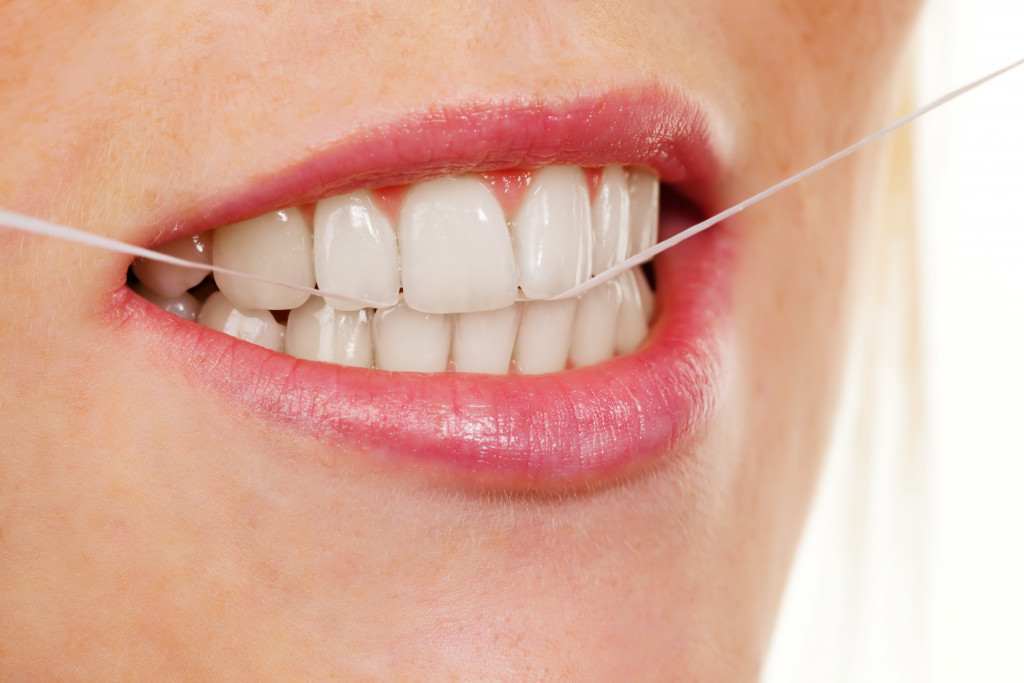 woman flossing her teeth