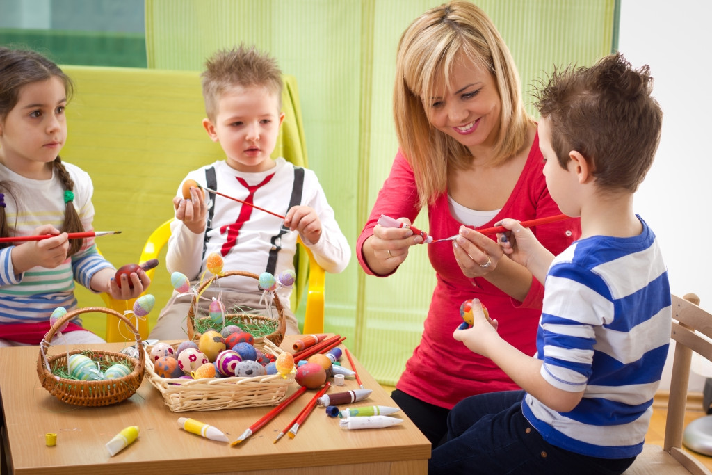 Children doing art with an adult