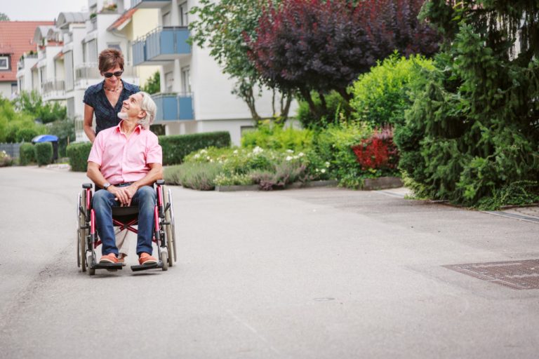 senior in a wheelchair with her assistant