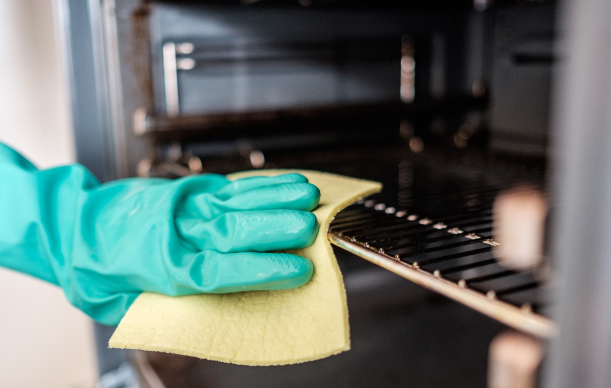 man cleaning the oven