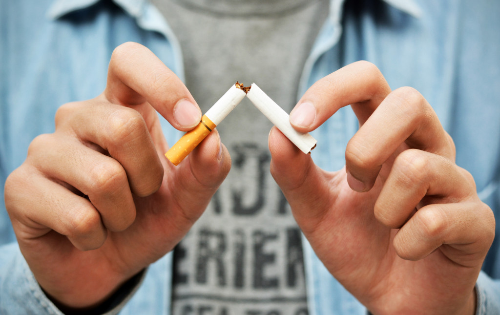 a person breaking a cigarette