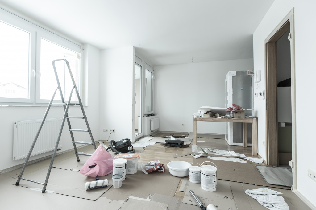 Home renovation in room full of painting tools