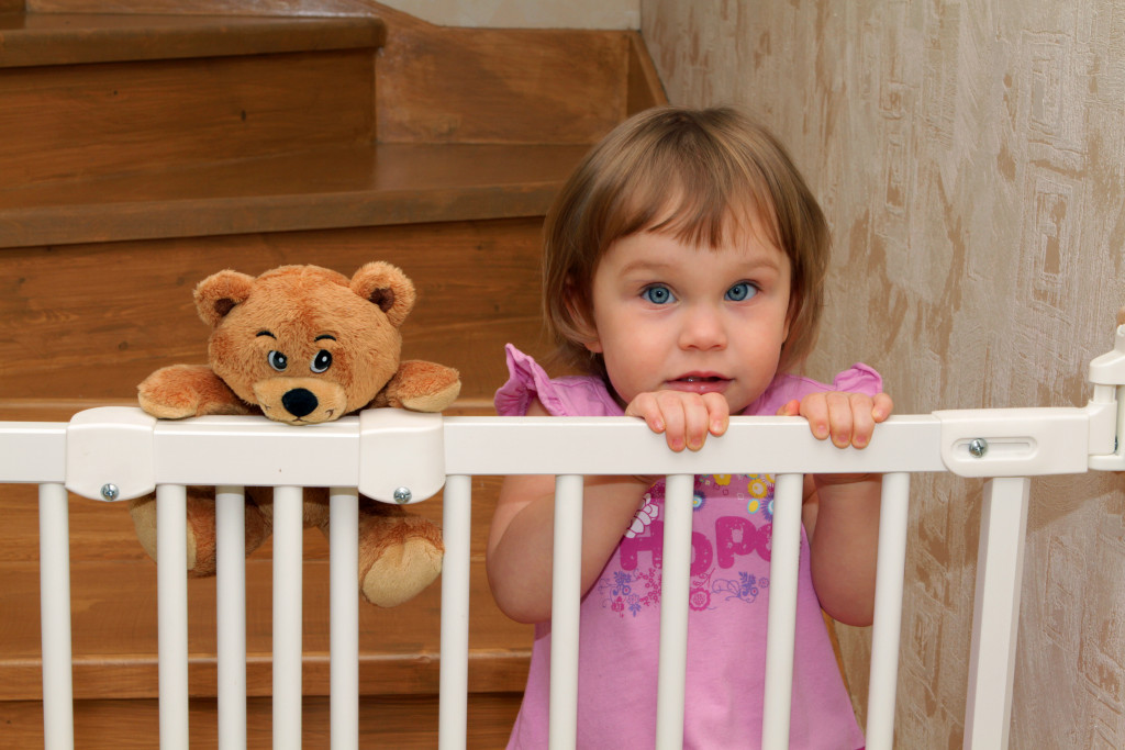 baby girl locked inside a gate