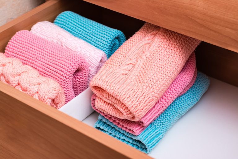 folded sweaters in a drawer