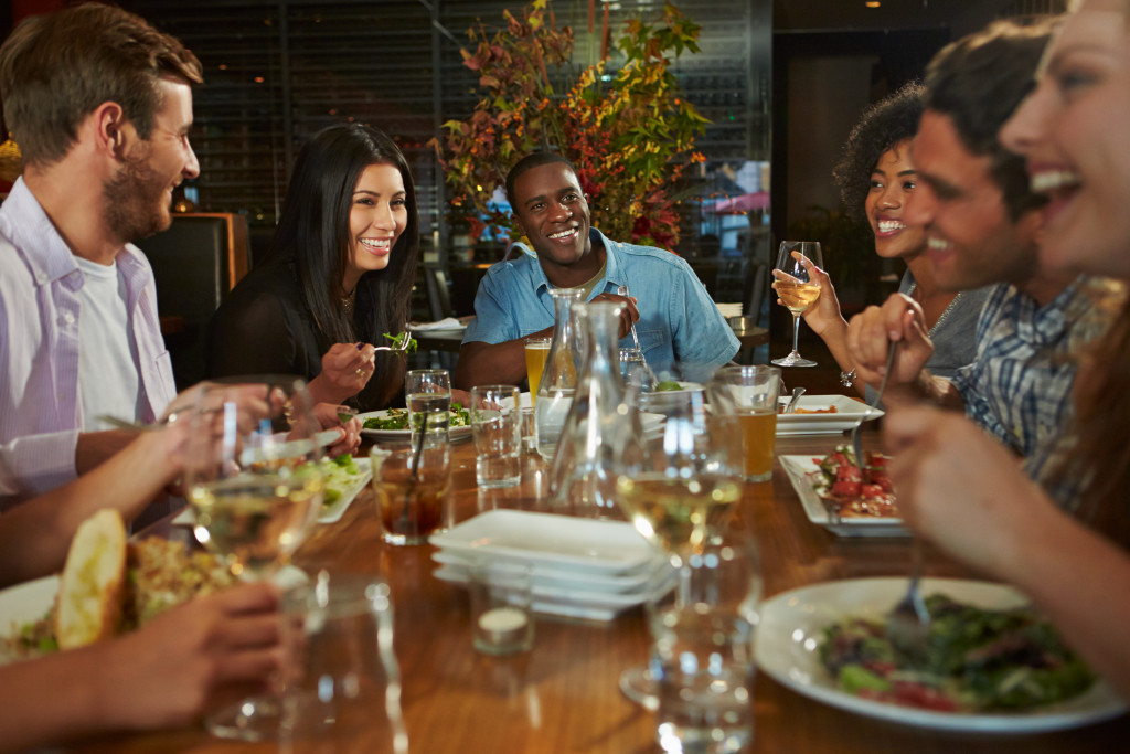 Group Of Friends Enjoying Meal In Restaurant