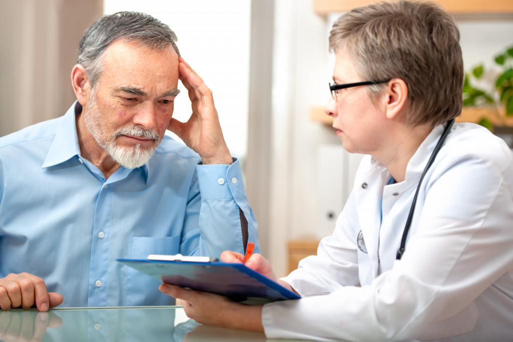 a woman mental care provider taking notes while talking to patient