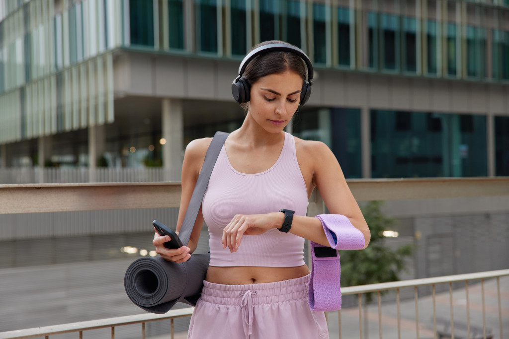 woman checking the time after working out in the gym