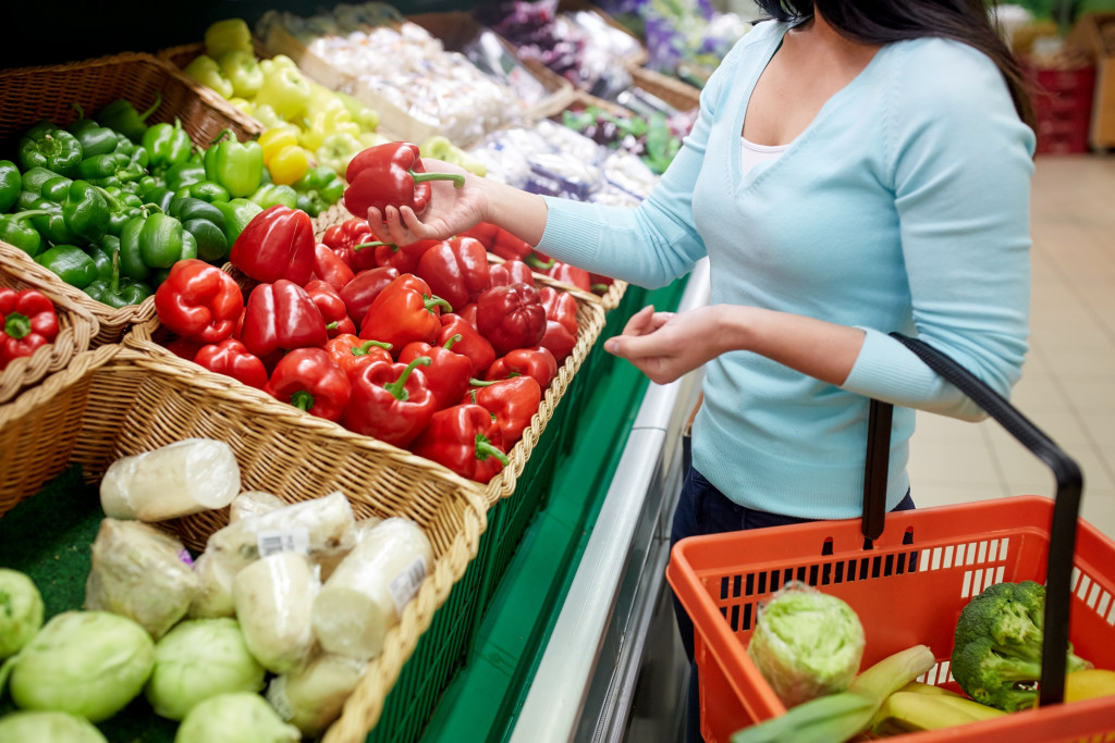 A woman shopping for vegetables in a grocery