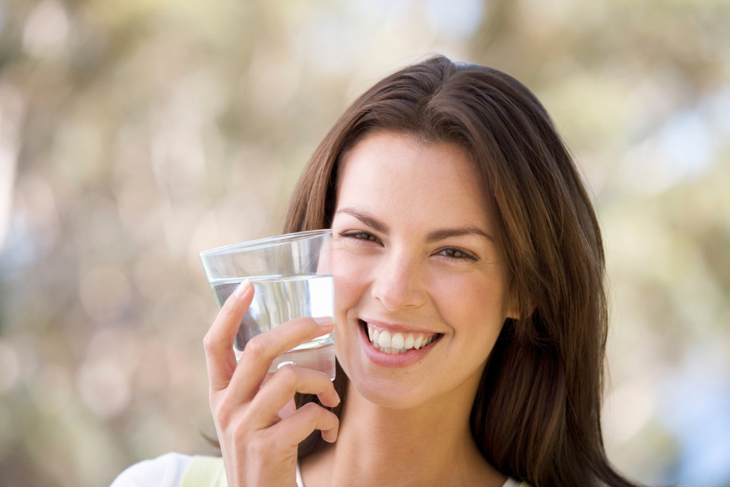 woman with a glass of water smiling