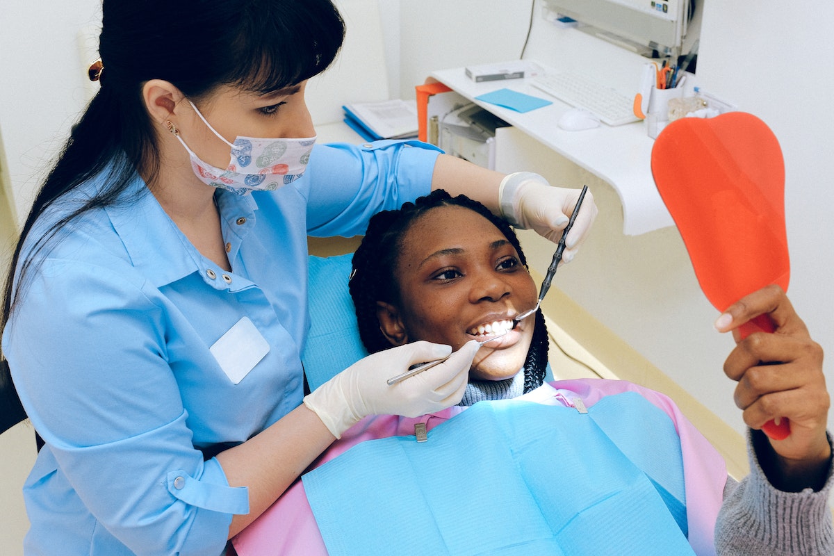 dentist with a happy woman patient