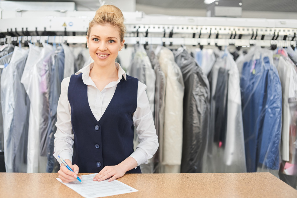 A dry cleaner owner ready to take your clothes