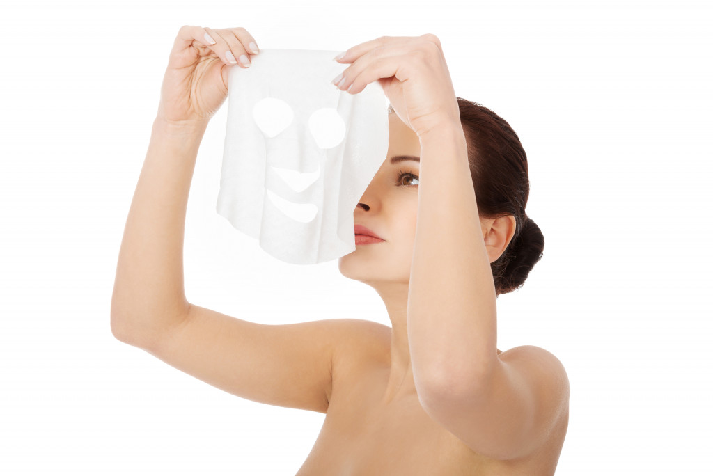 Beautiful woman with collagen mask on face